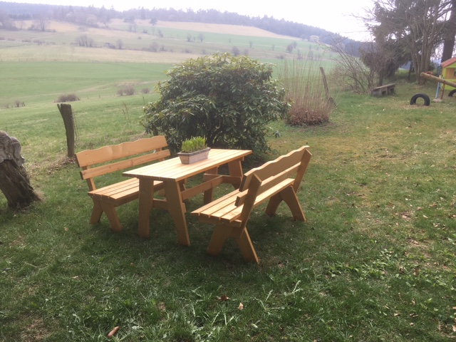 Bij het speelveld een gezellige tafel met banken